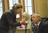 Julia Manning demonstrates mobile technology to Earl Howe